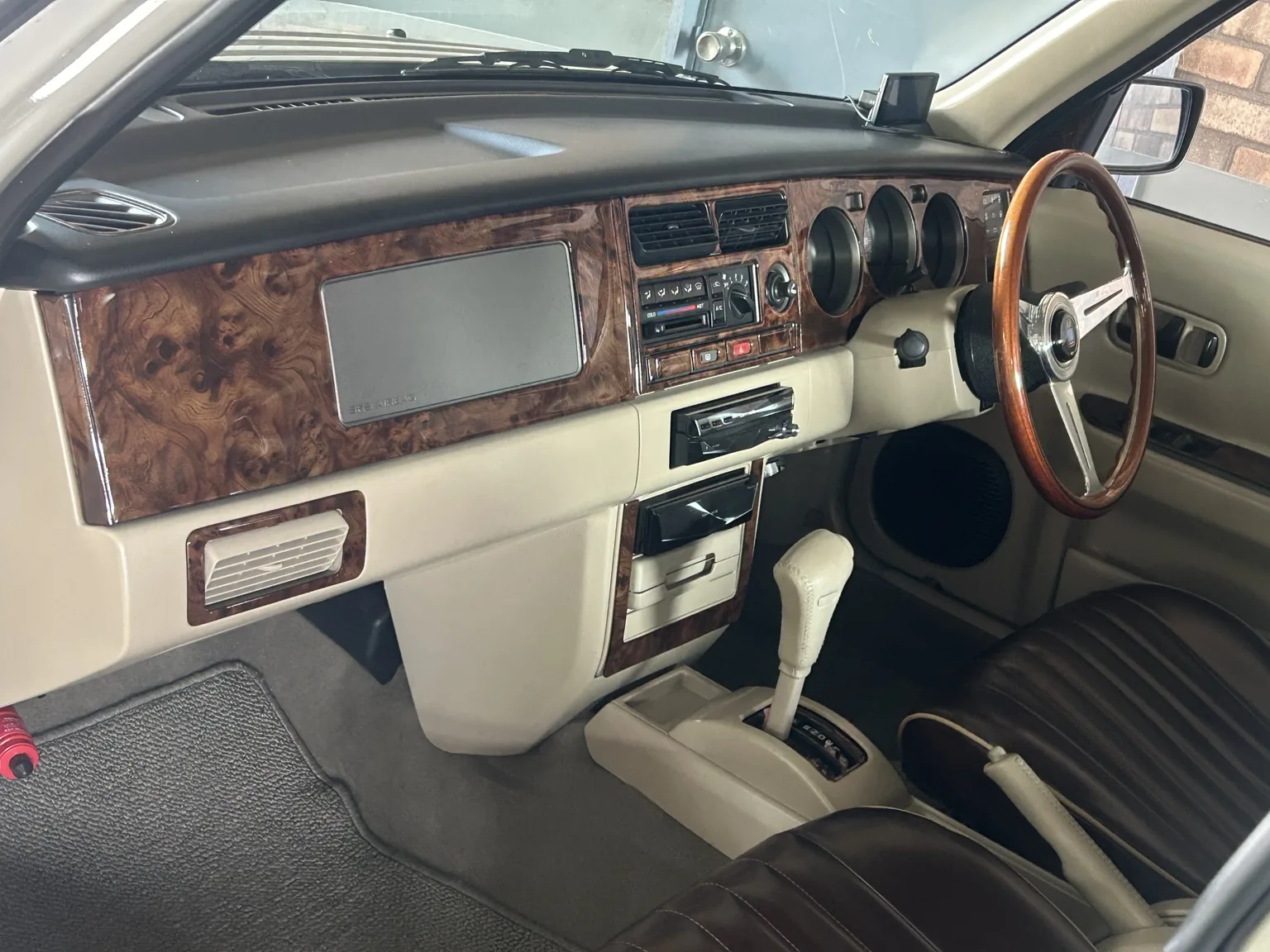 Custom Nissan Rasheen wood-grain dashboard and steering wheel