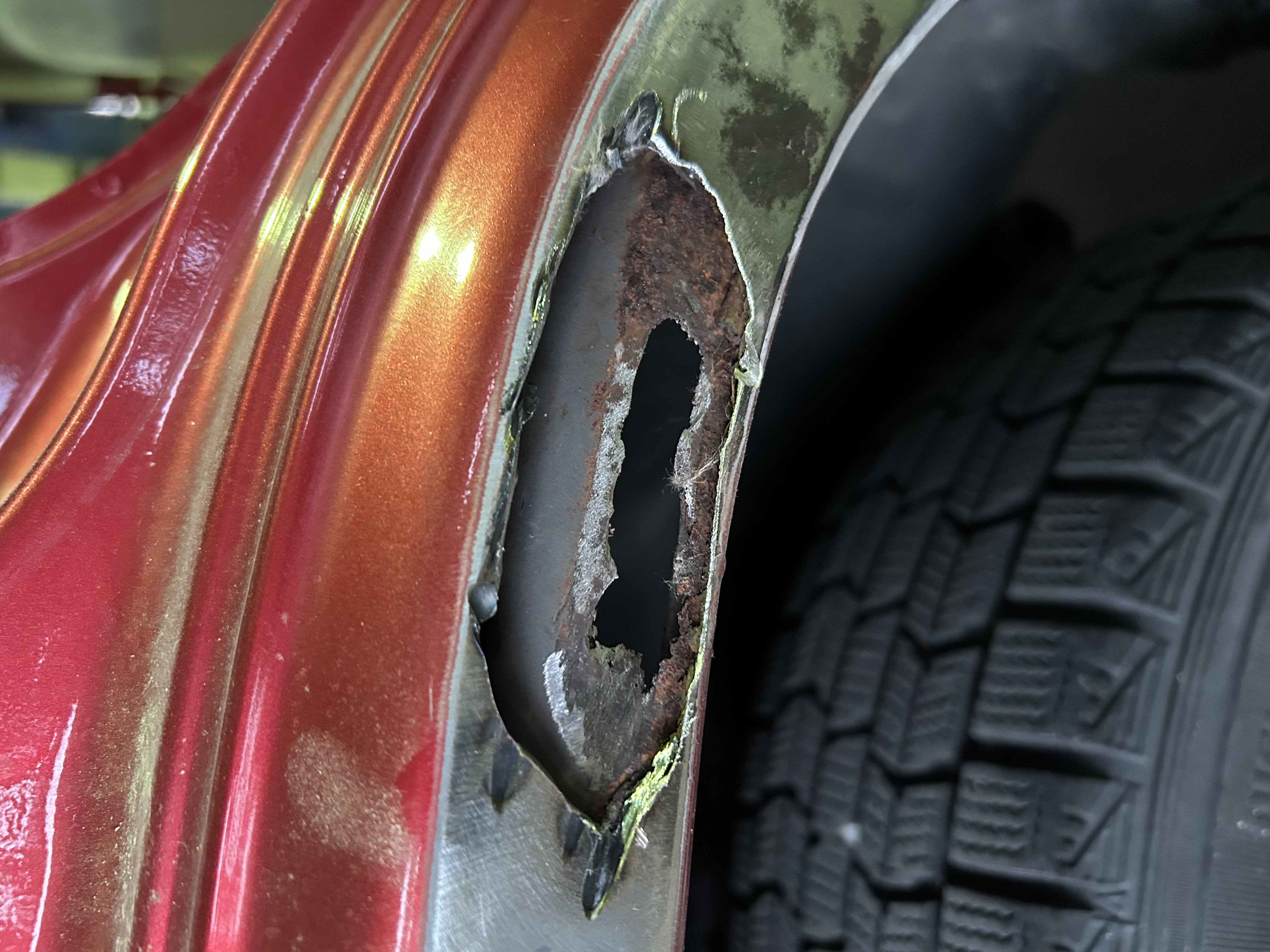 Removing the outer layer revealed corrosion inside the wheel-arch structure.