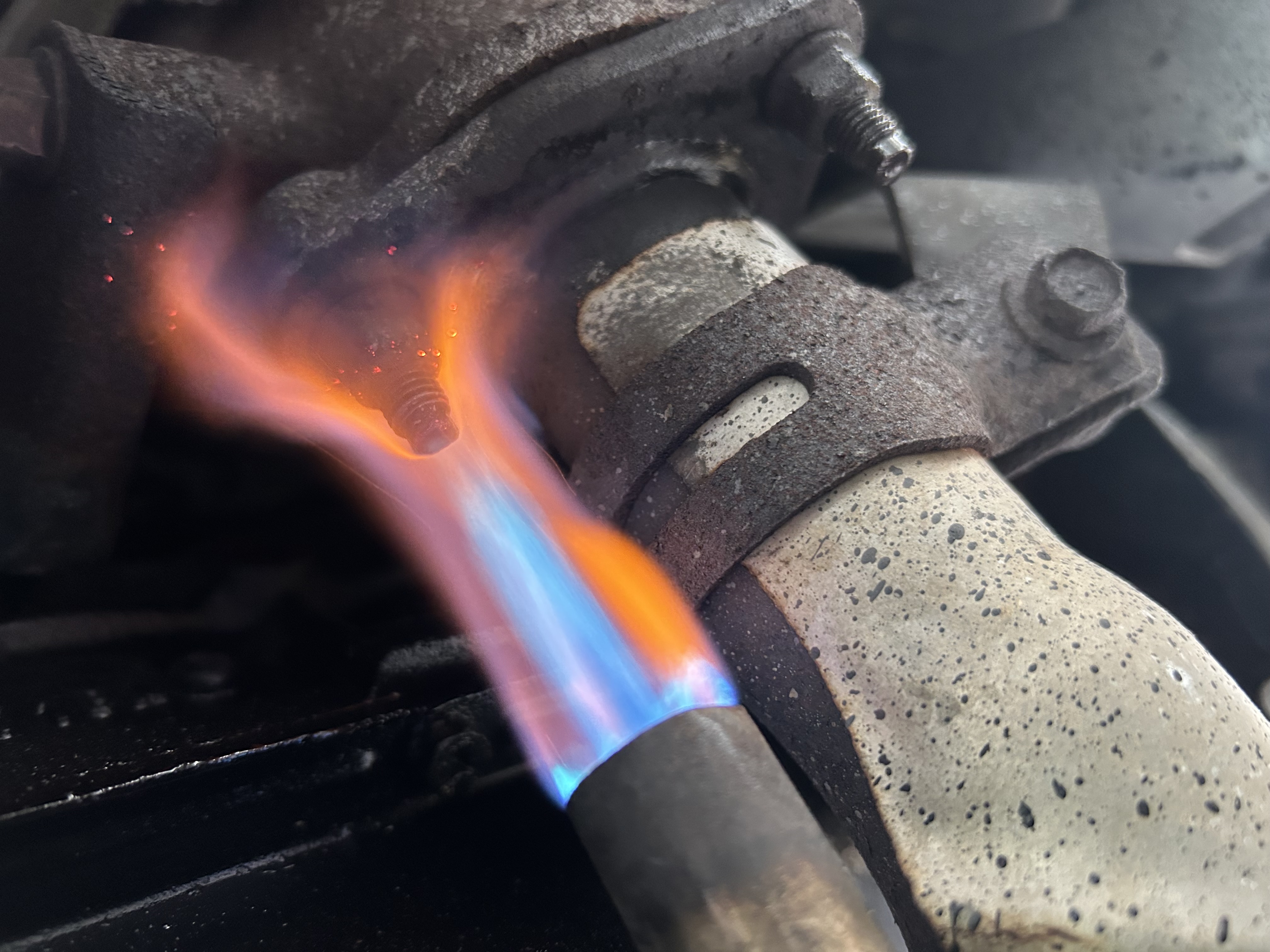 Controlled heat being applied to a heavily seized exhaust fastener.