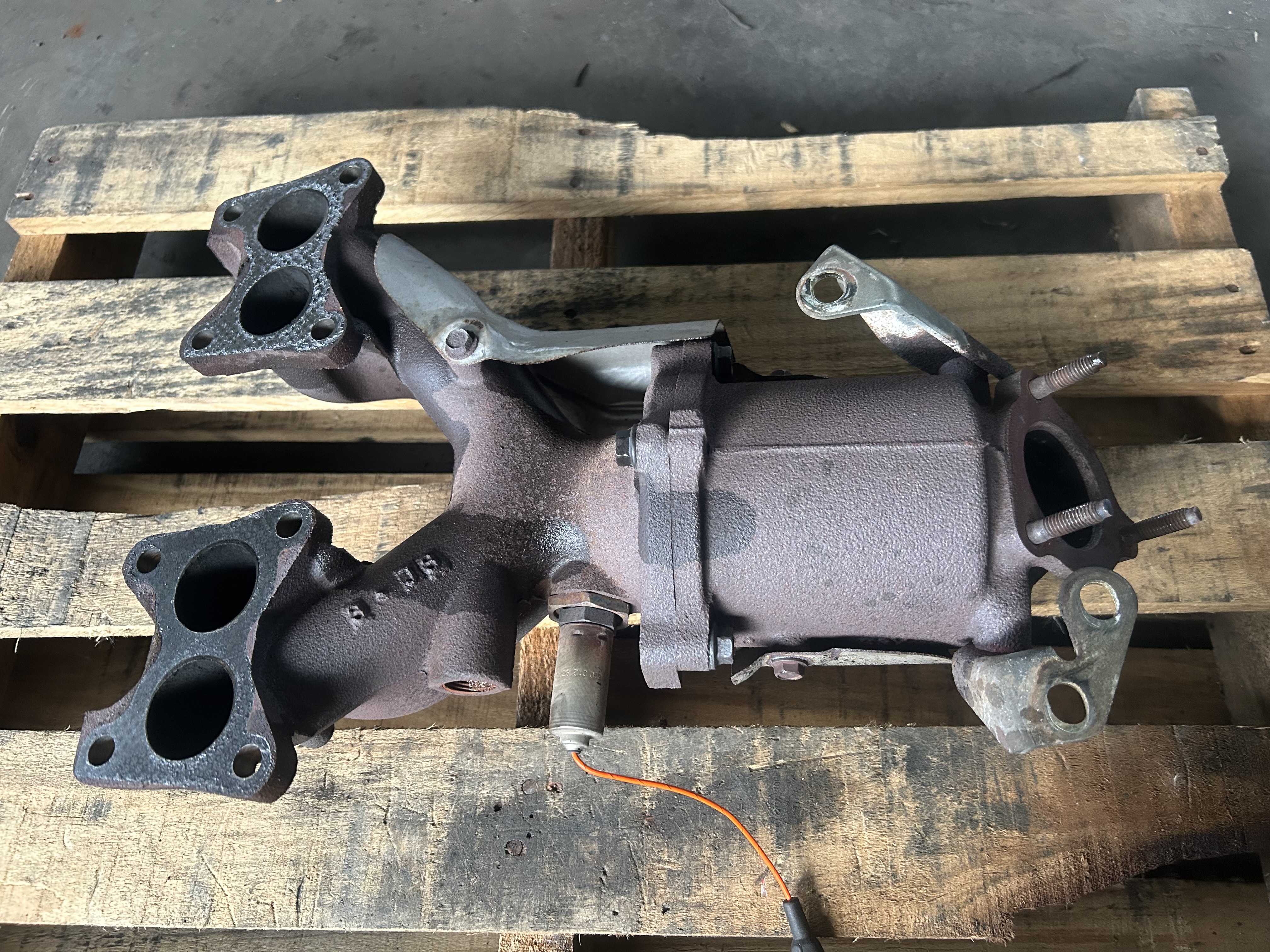 Close-up of the factory exhaust manifold]