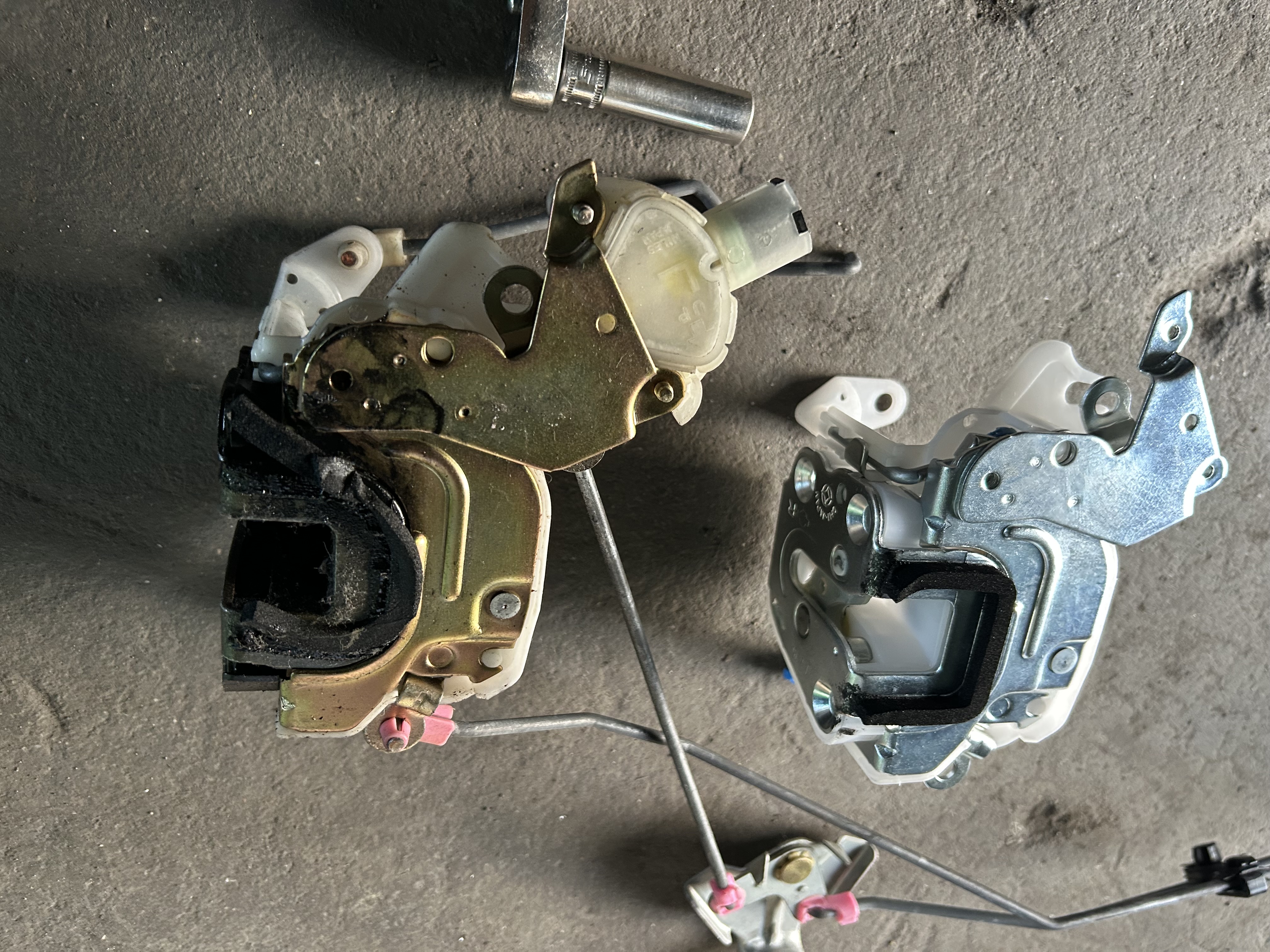 The removed door lock assembly and replacement part