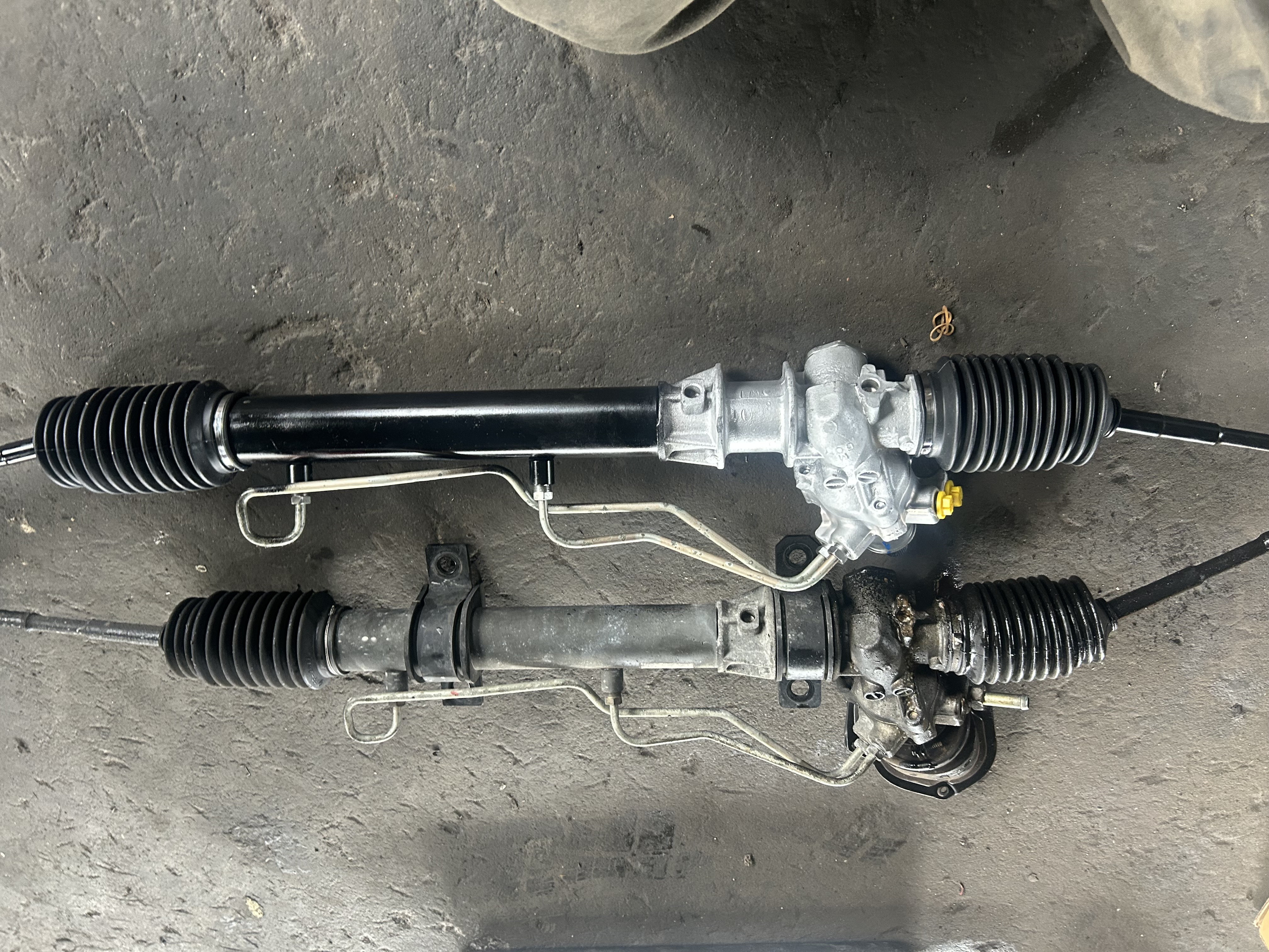 The original power steering rack and the professionally rebuilt replacement unit.