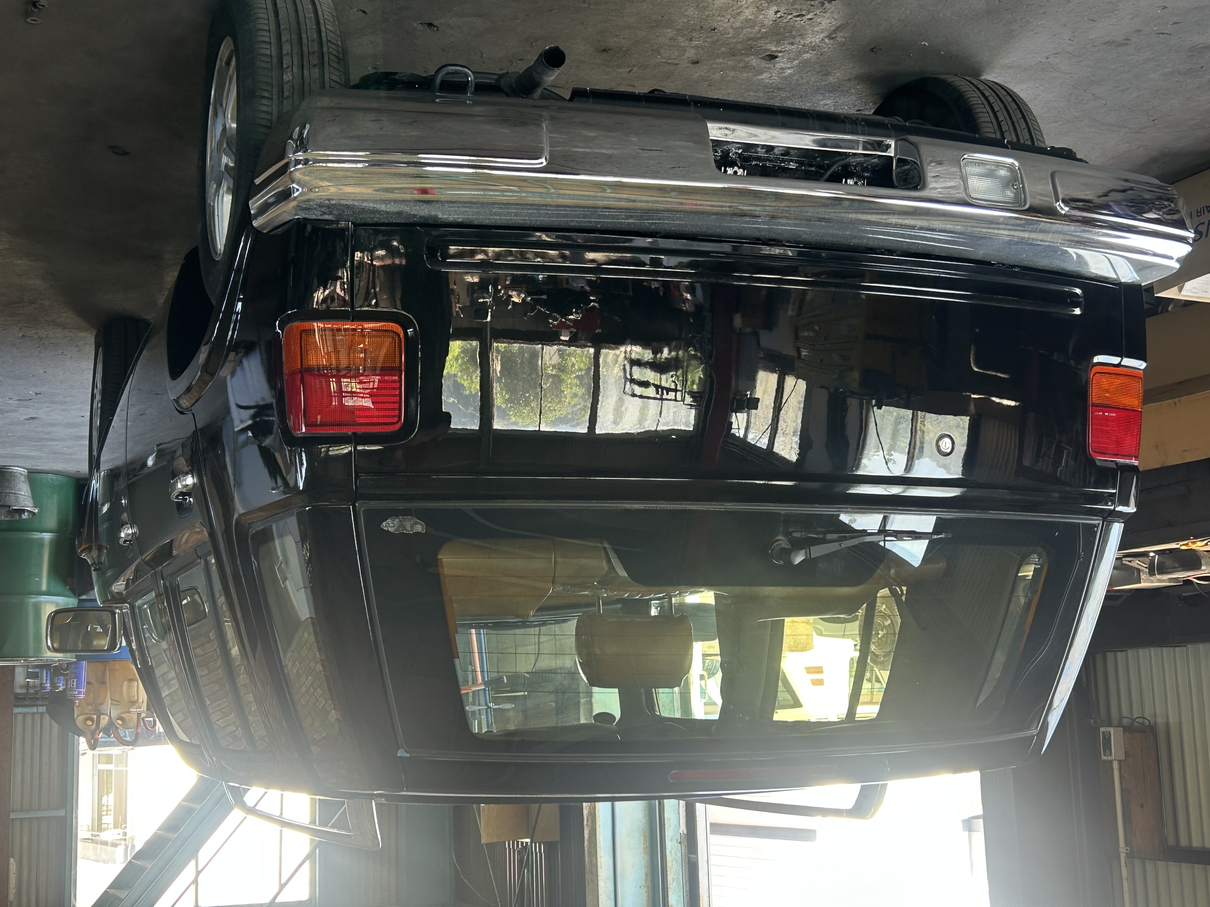The rear continues the restrained black-and-chrome theme.