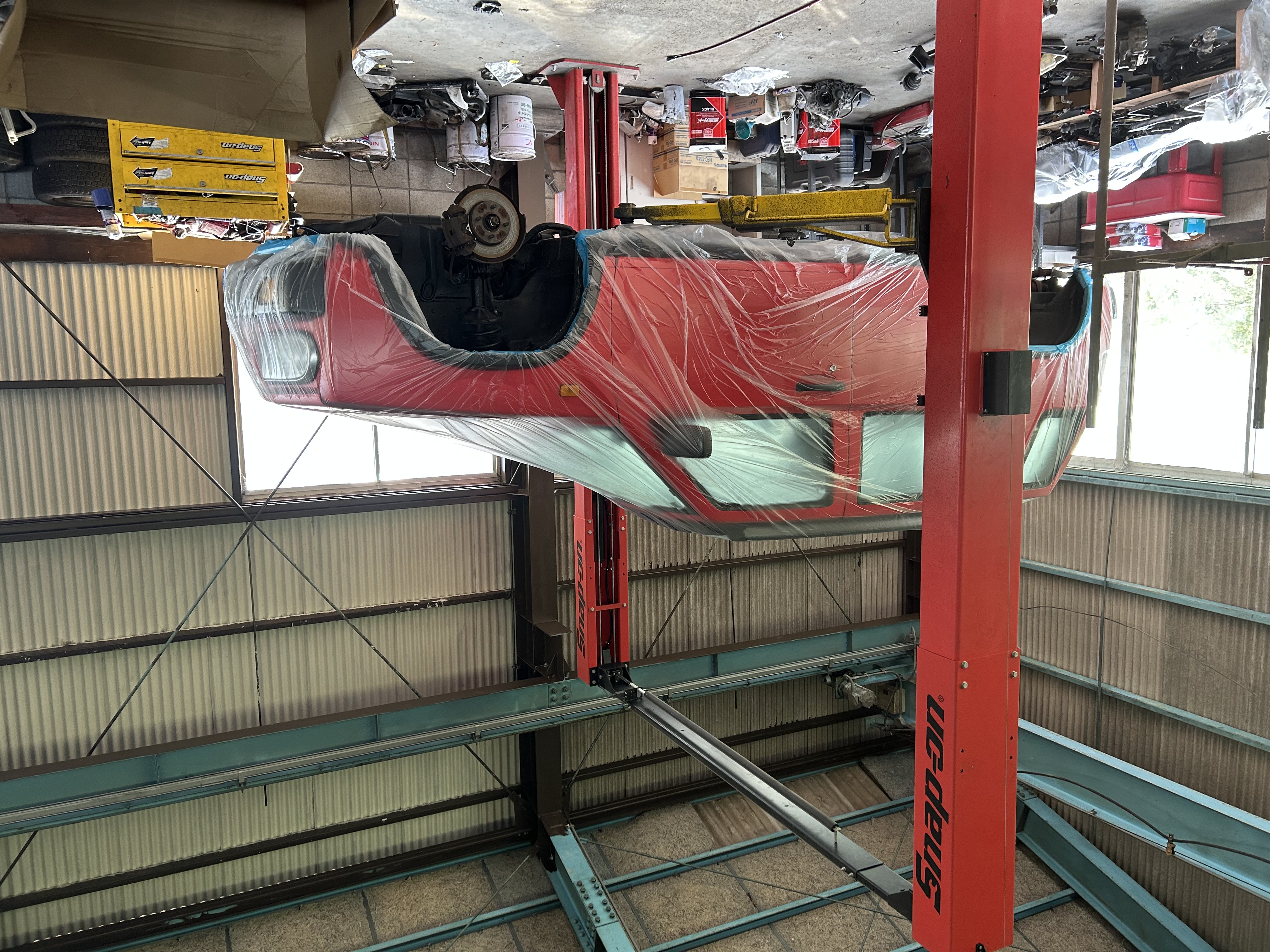 Nissan Rasheen lifted and masked for underbody work