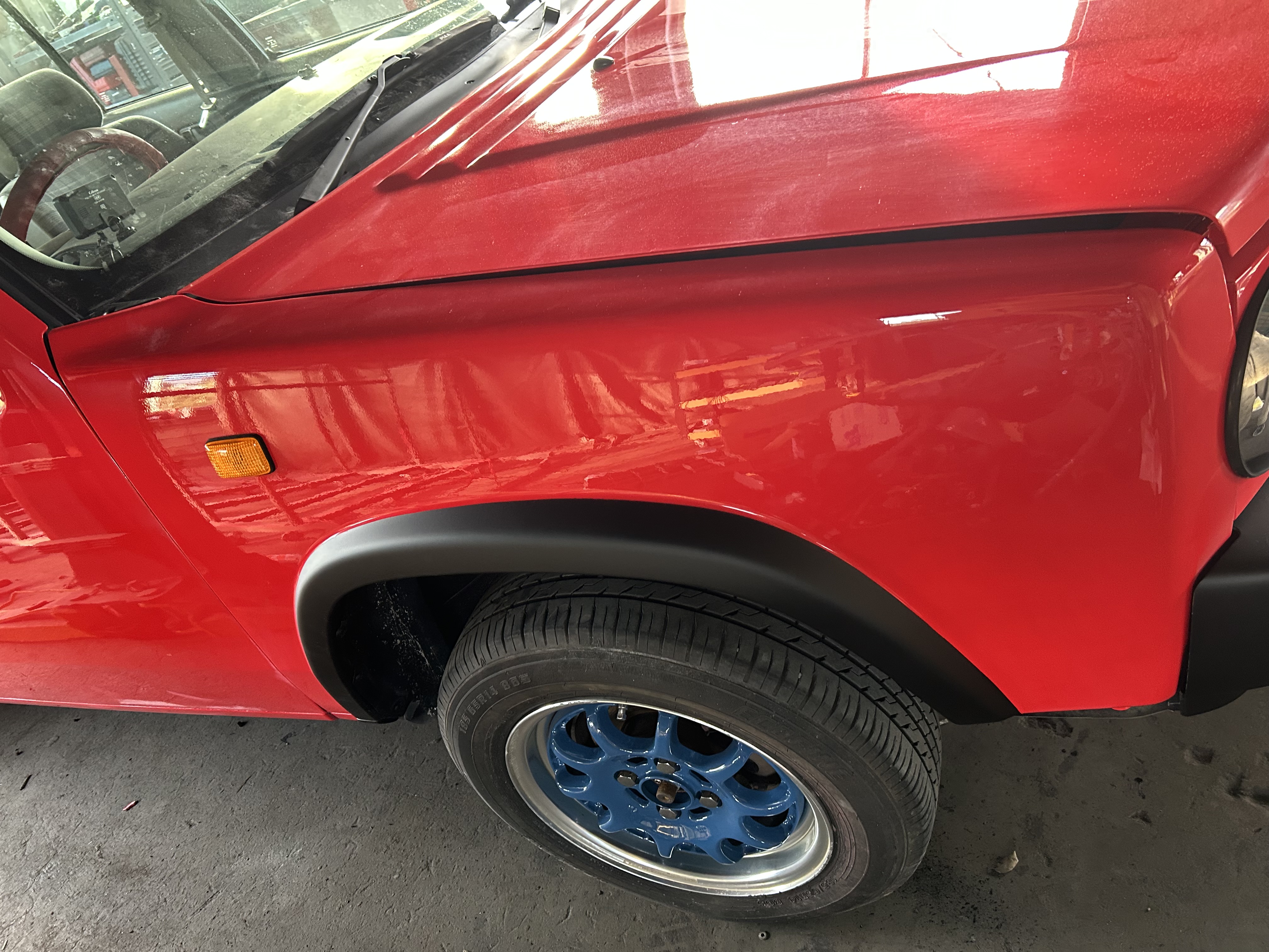 Close-up of the finished red front fender and black trim
